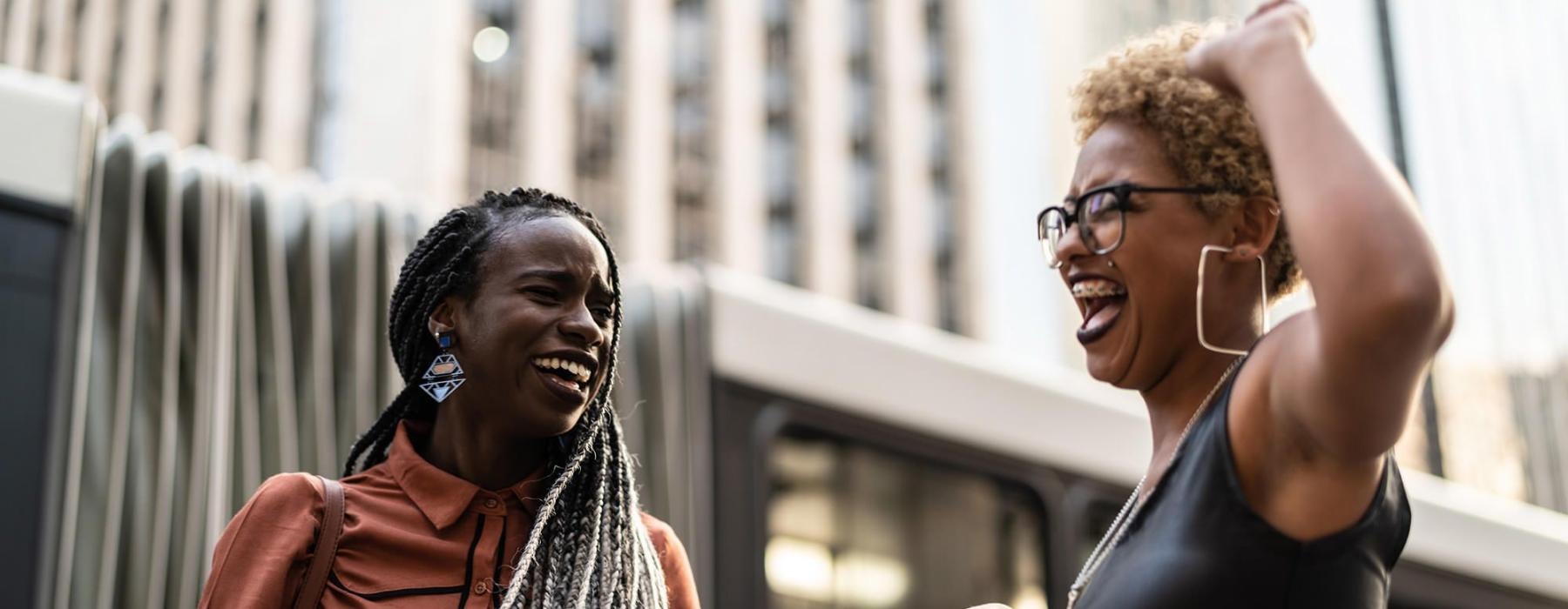 women laughing together in the city