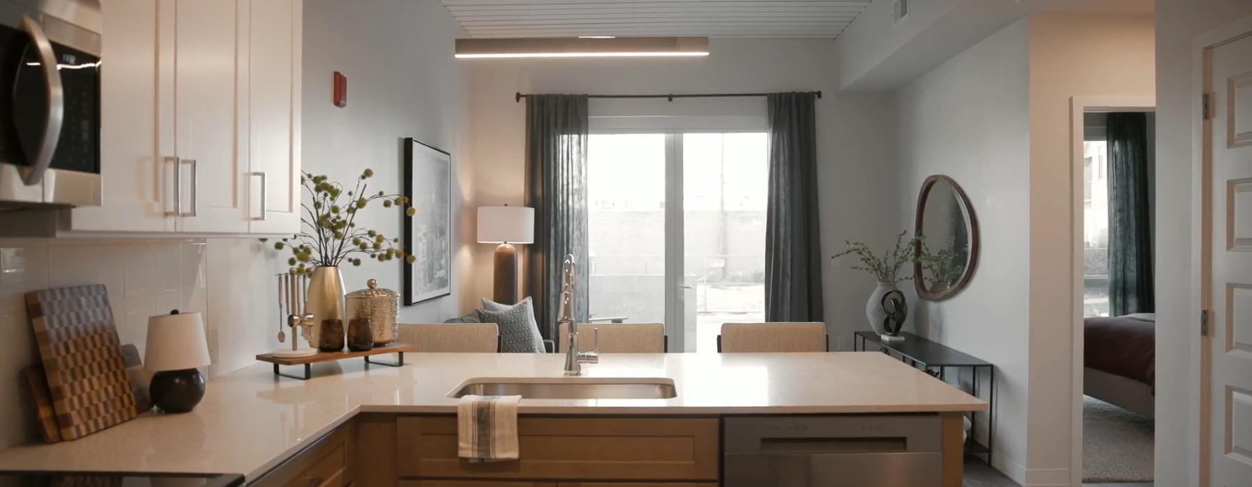 brightly lit model kitchen and living room