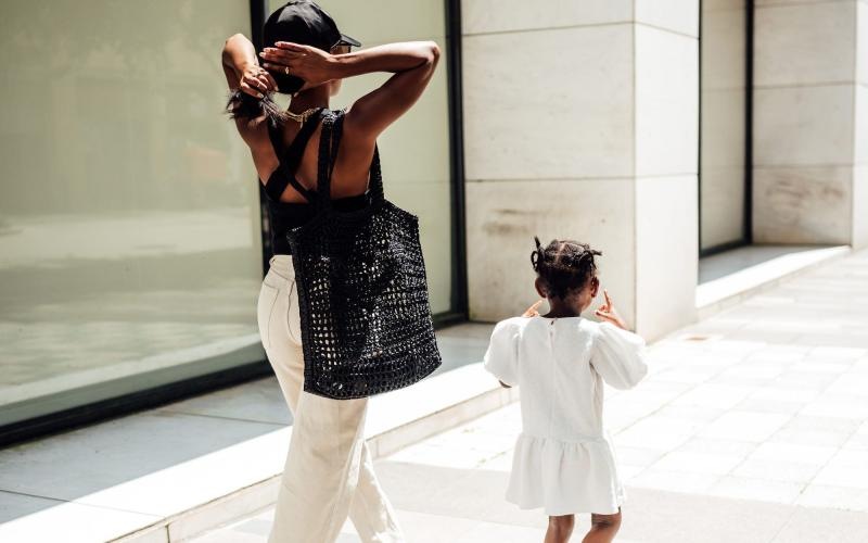 a woman walking with her child